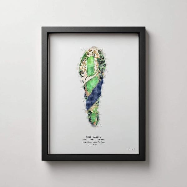 Framed golf course art print featuring a watercolor illustration of Pine Valley hole 5 layout in green, blue, and beige tones, displayed on a light gray wall.